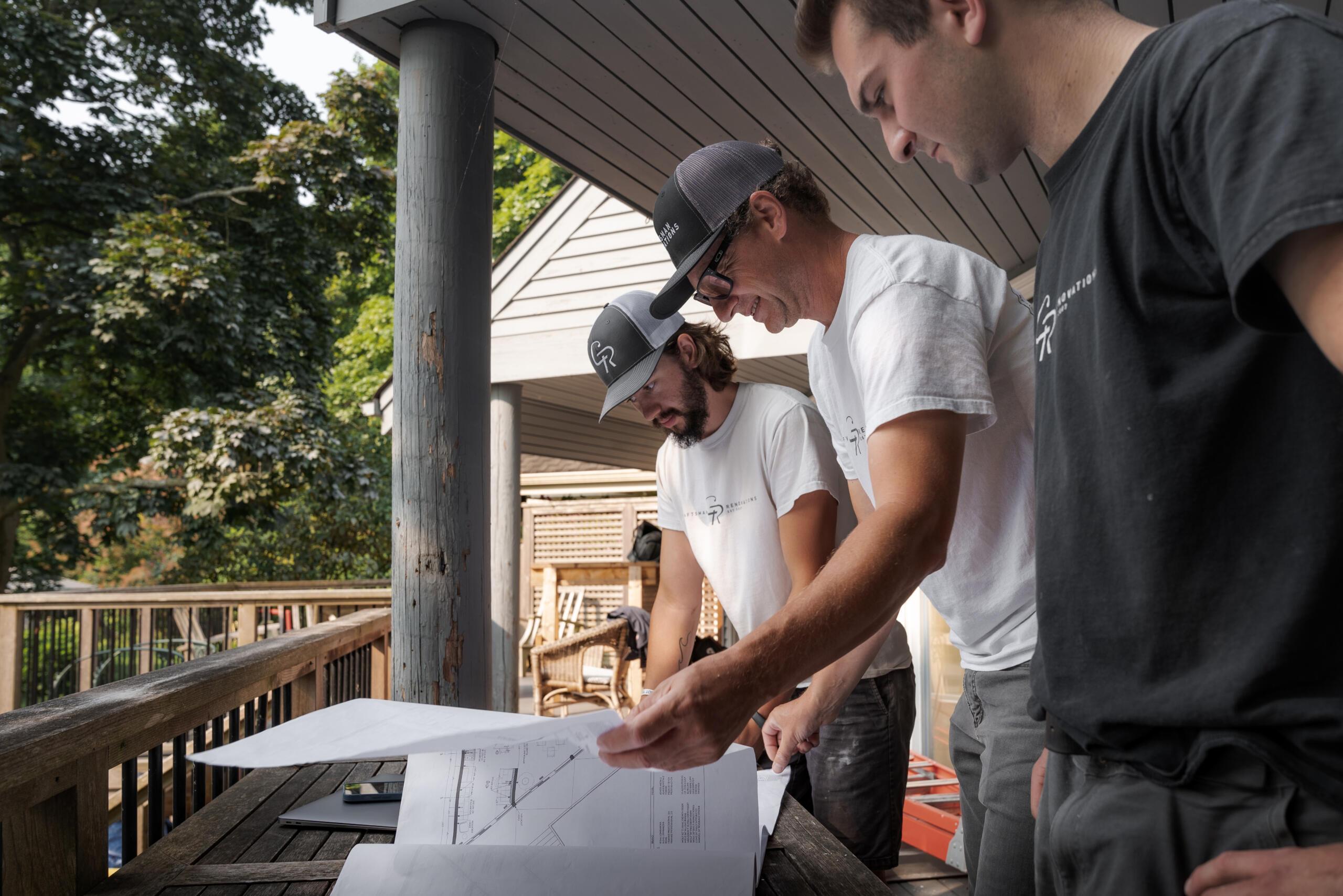 A1 Round Rock crew member reviewing patio cover drawings at a job site in Forest Creek