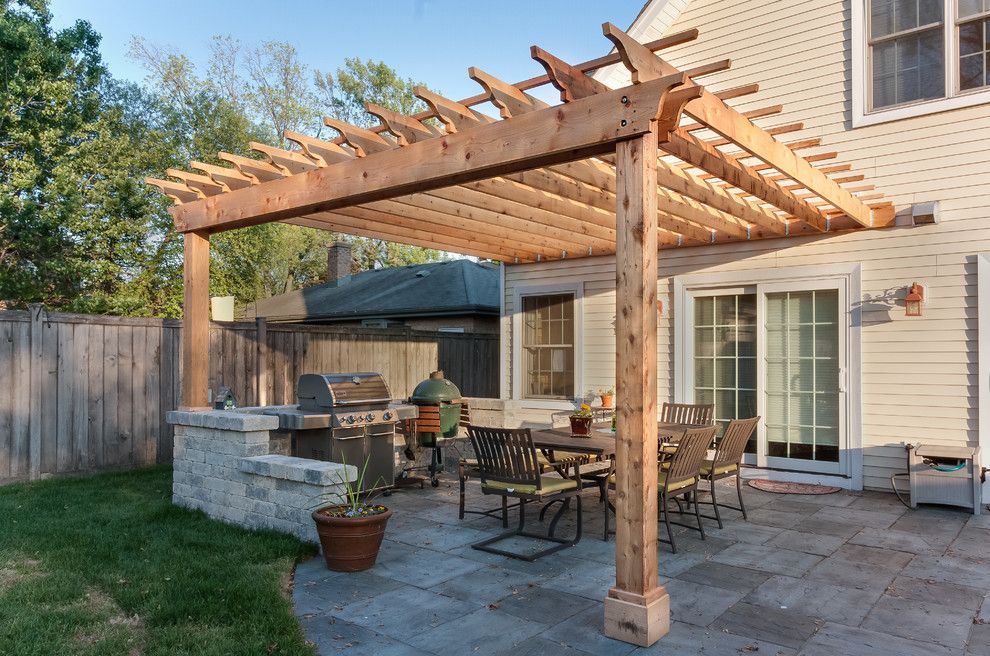 Cedar pergola over outdoor dining in an established North Austin backyard