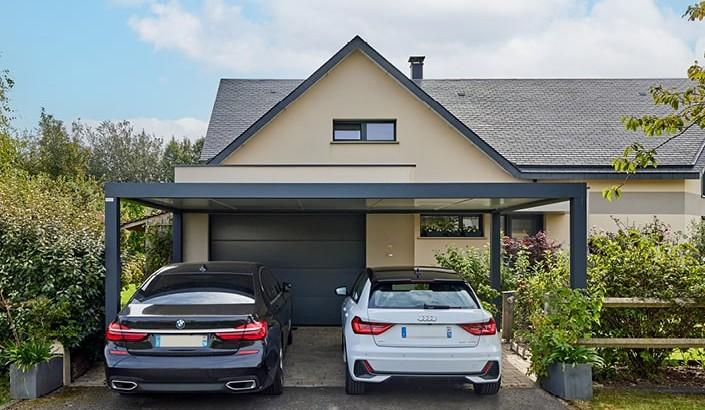 Attached aluminum carport matching the roofline of a Round Rock home with two vehicles underneath