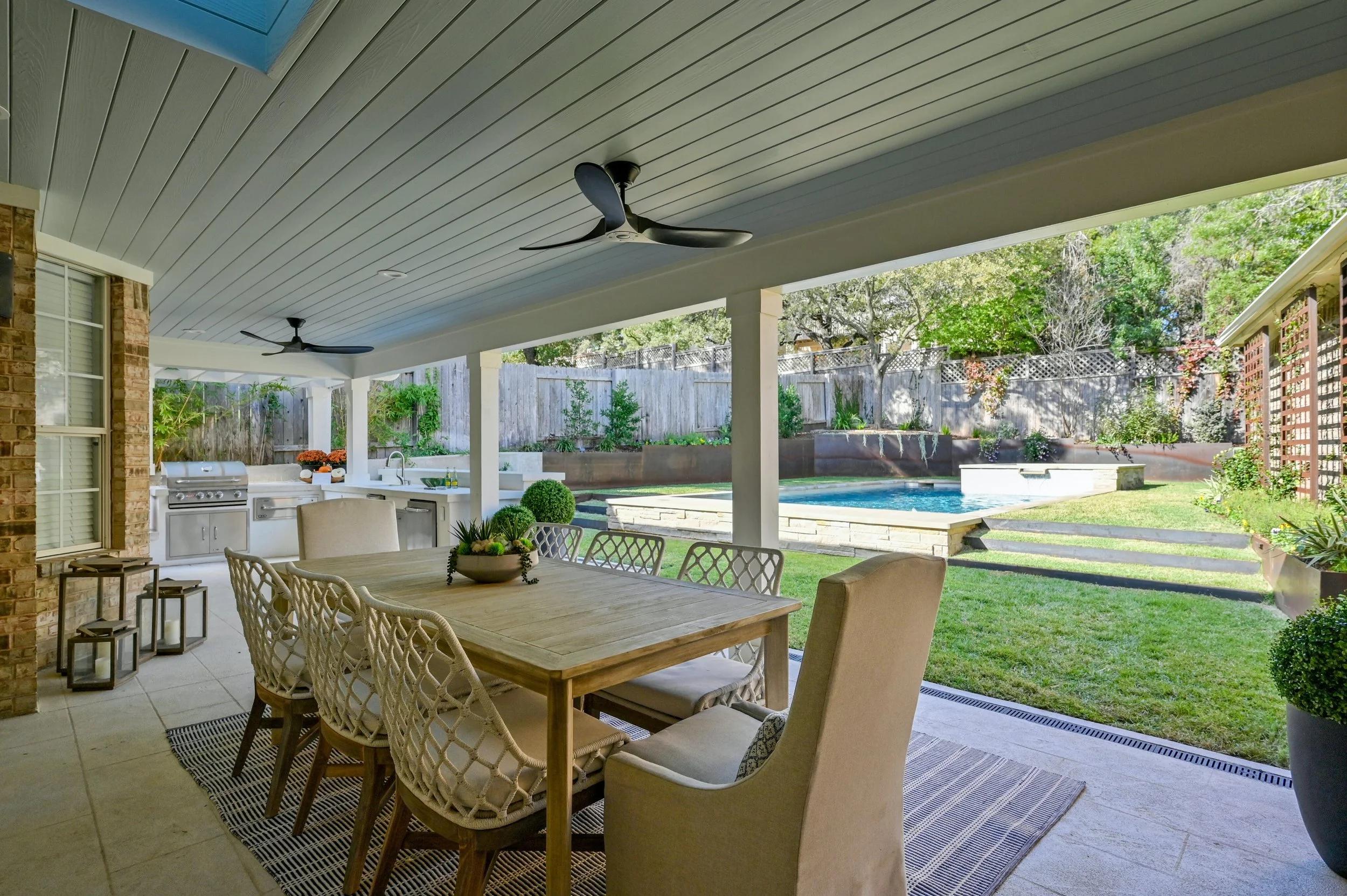 Family relaxing under a new insulated aluminum patio cover in Teravista, Round Rock