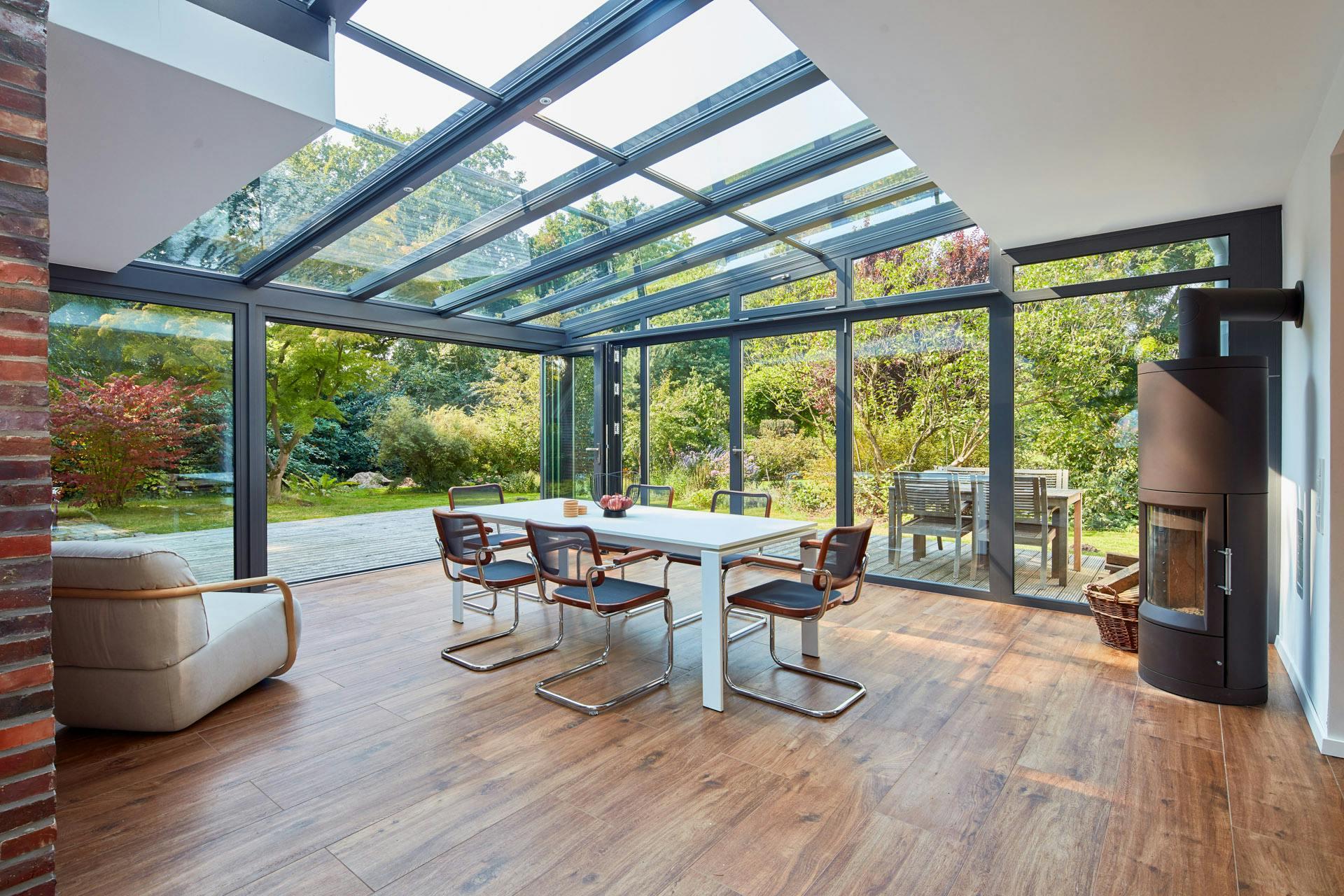Glass-walled sunroom with insulated roof overlooking a Round Rock backyard