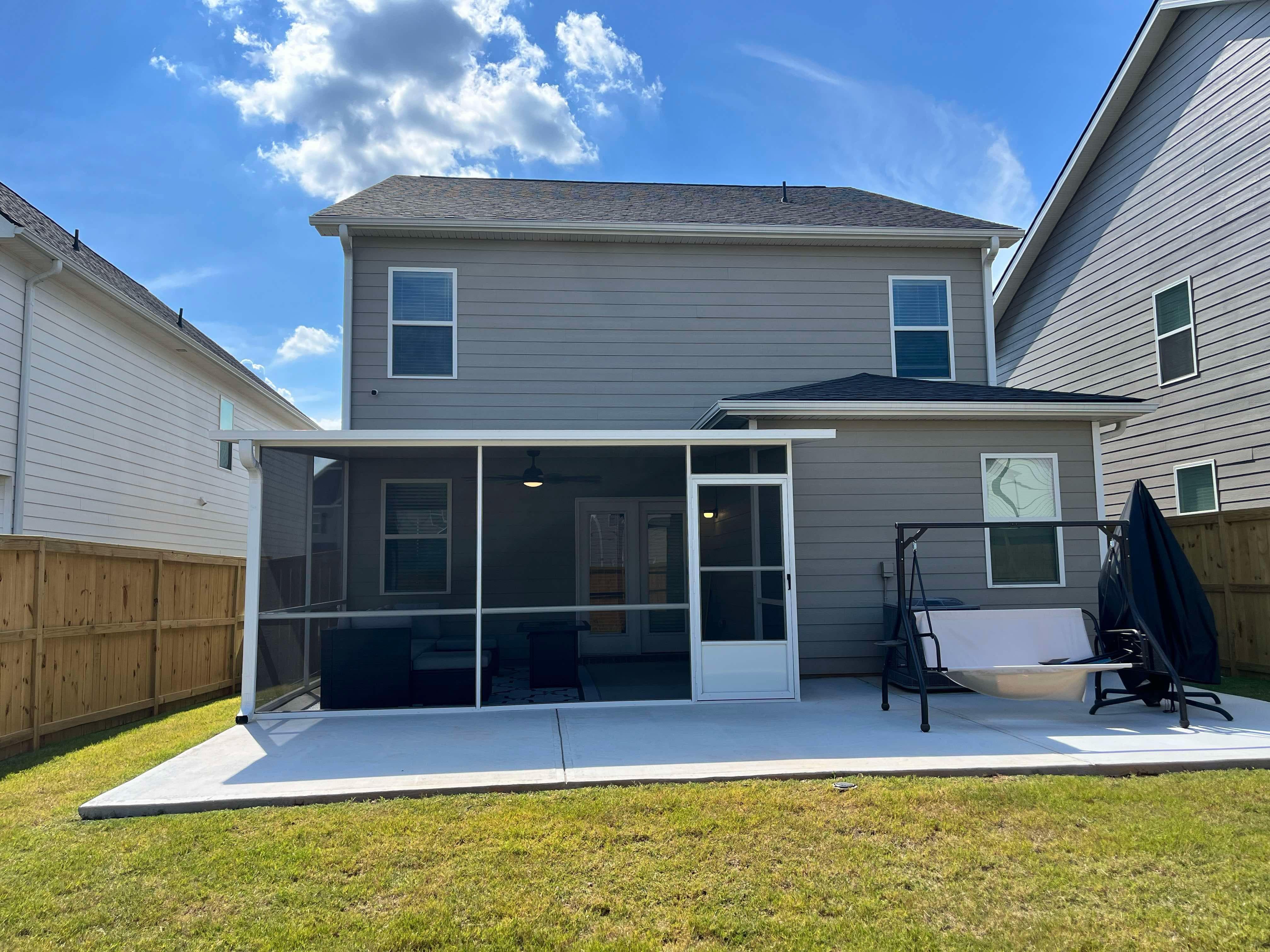 Insulated aluminum patio cover with screens on a two-story home in Falcon Pointe, Pflugerville