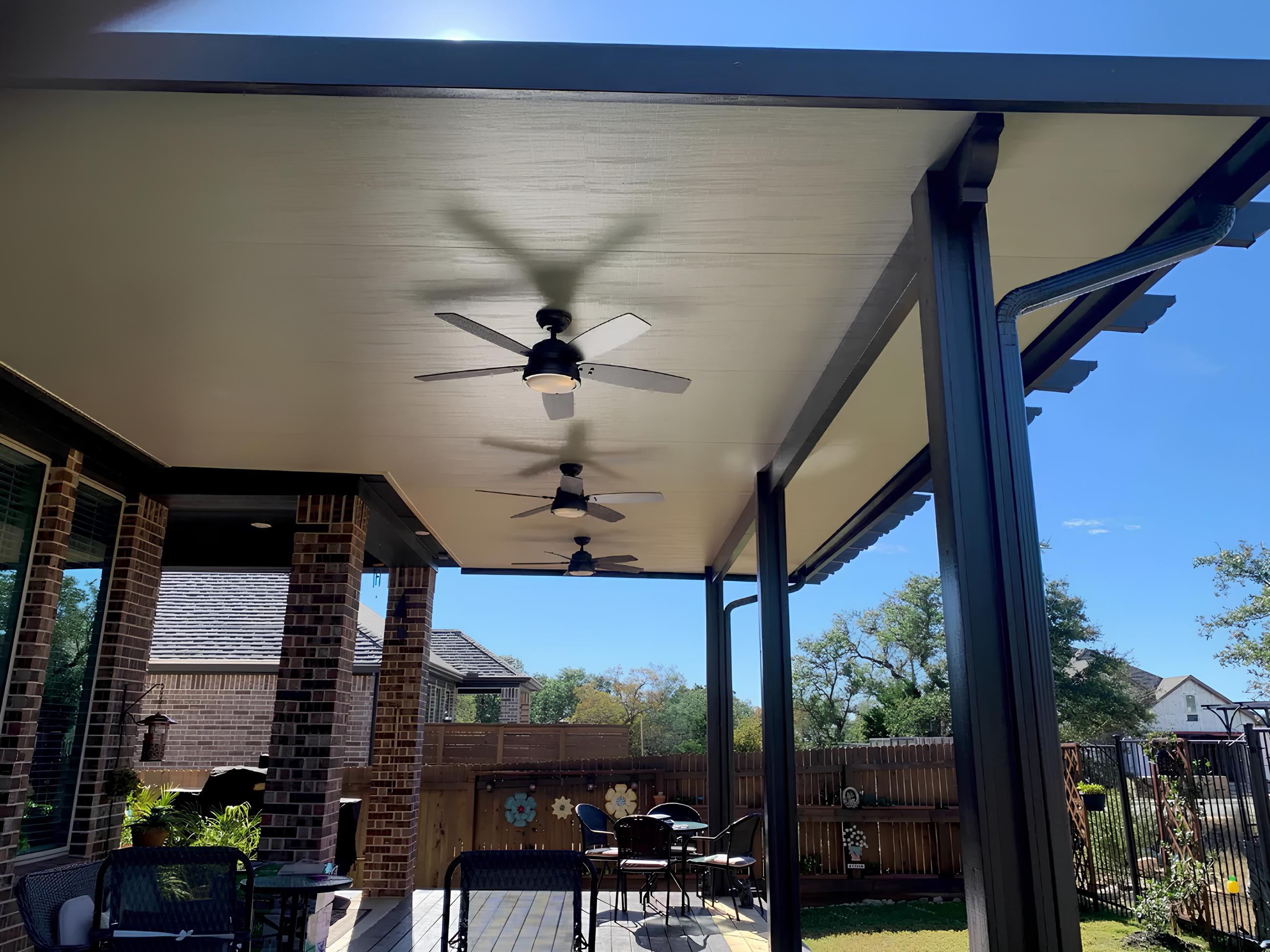 New aluminum patio cover with fans on a Crystal Falls home in Leander