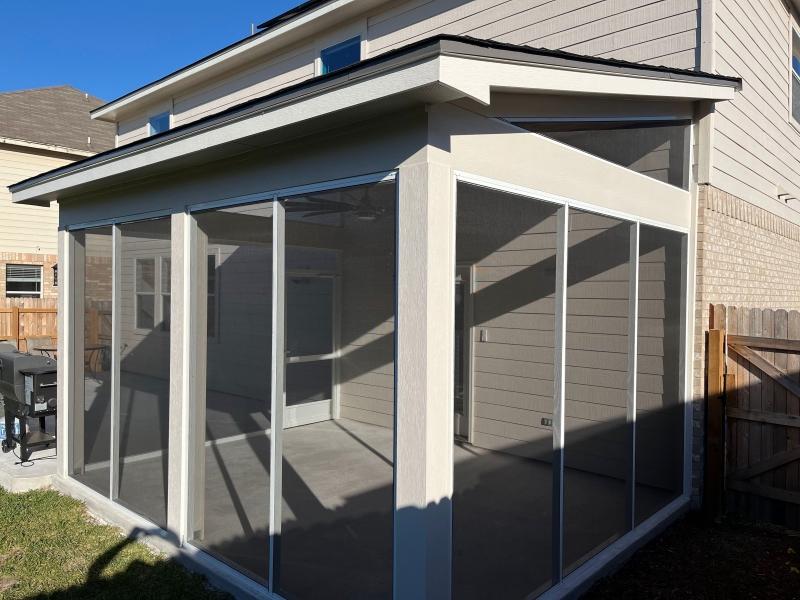 New aluminum patio cover with screens on a Star Ranch home in Hutto