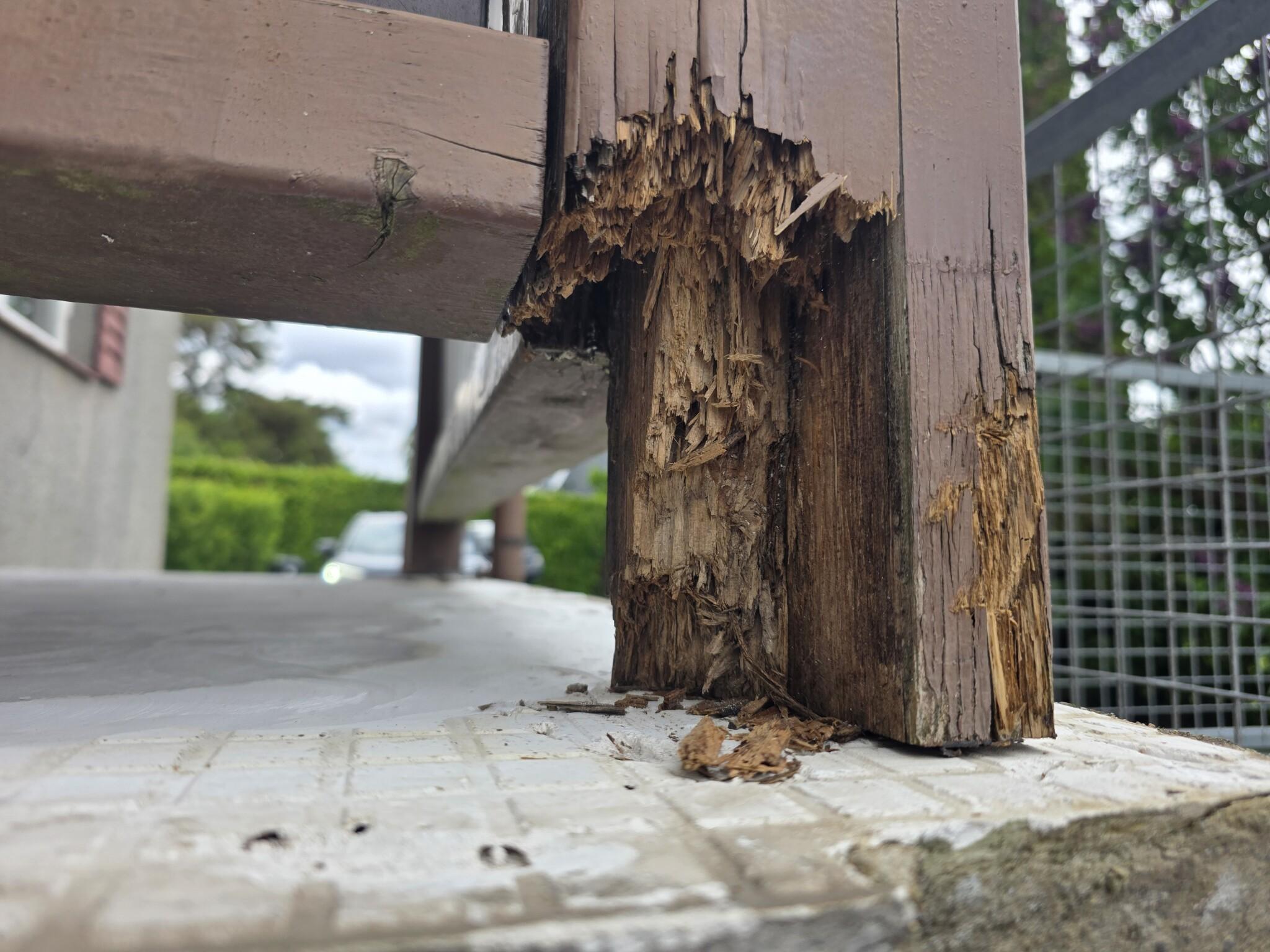 Rotted wood post base on an older patio cover in Round Rock before repair