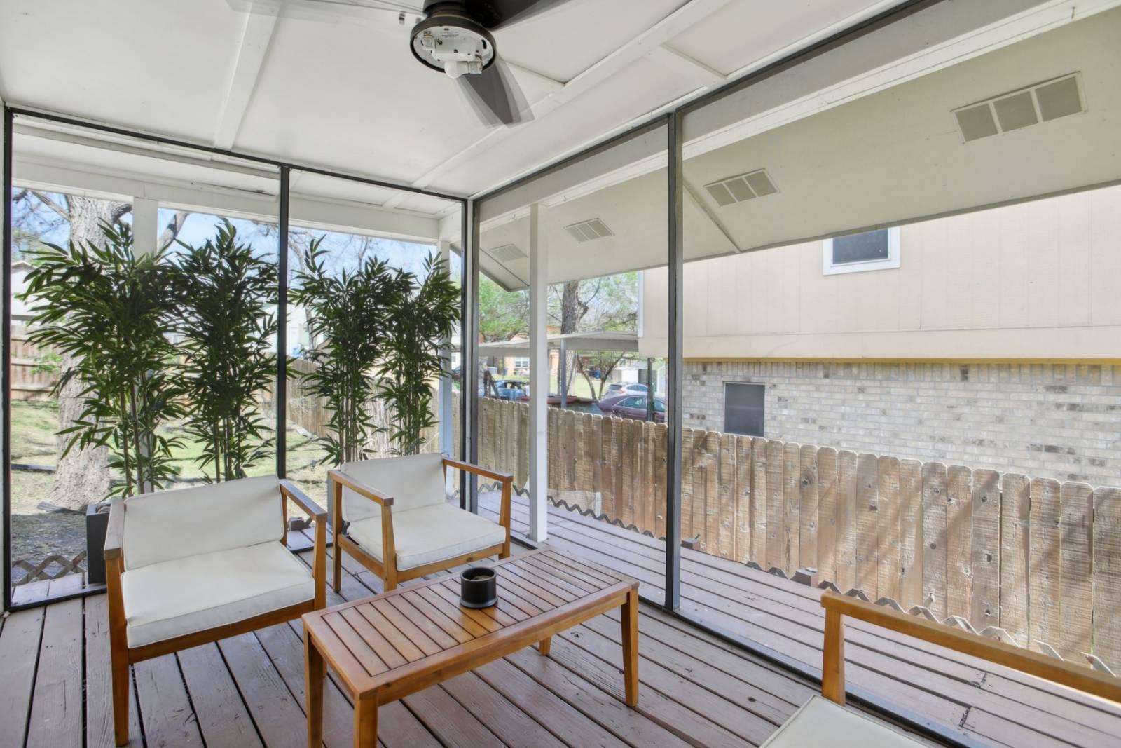 Screened patio enclosure with a ceiling fan on a home near Lake Creek in Round Rock