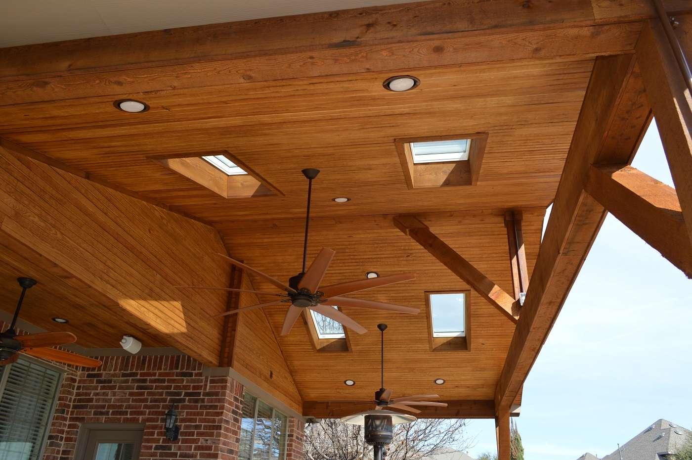 Stained cedar beams and tongue-and-groove ceiling beneath a wood patio cover in Round Rock