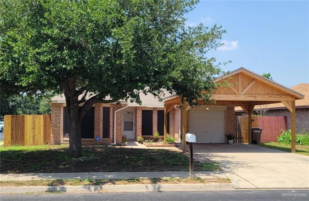 Wood carport with shingle roof matching a Round Rock home